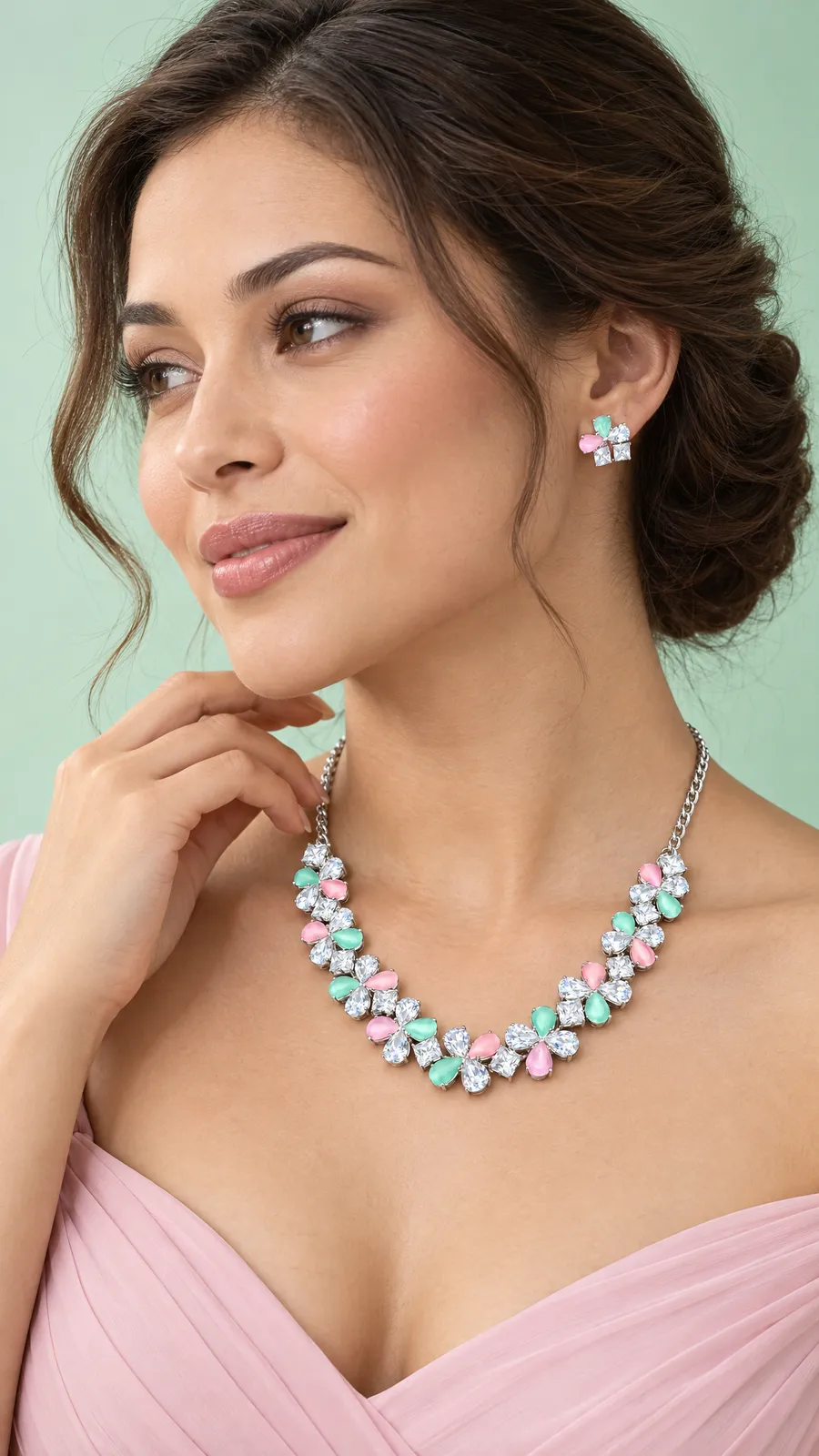 AI-generated with Oranokai: a woman in a soft pink dress wearing a crystal necklace and matching earrings with pink and mint stones, against a pale mint background. A gift-guide style shot made from a product photo of the jewellery set.