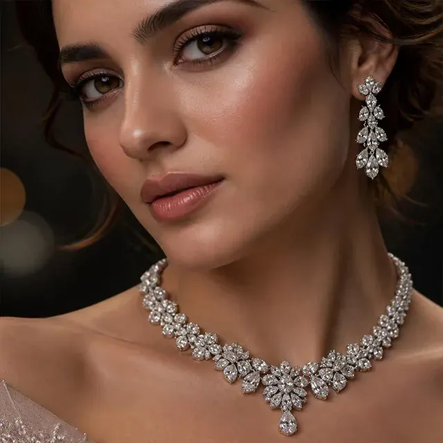 Close-up of a woman wearing a diamond necklace and matching drop earrings
