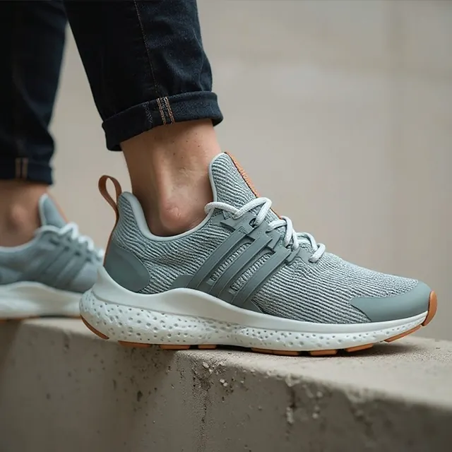 Close-up of a gray running shoe worn on someone's foot, stepping onto a concrete ledge